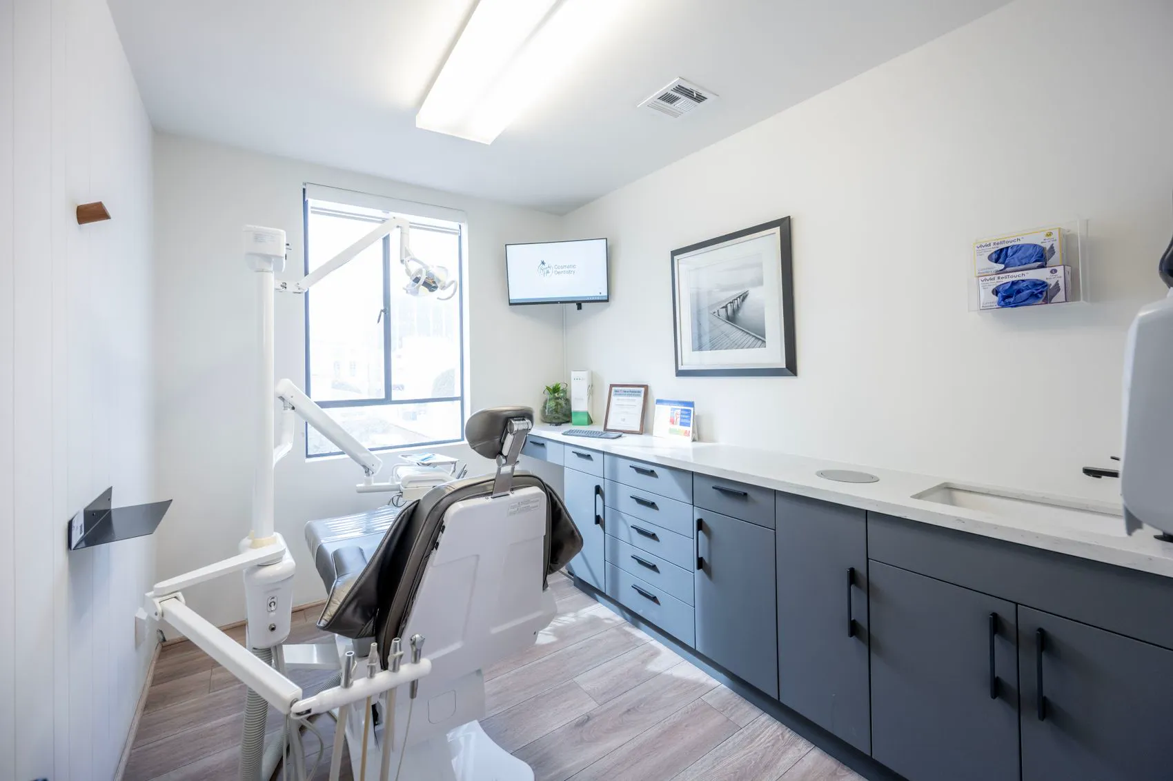 A bright treatment room with a dental chair